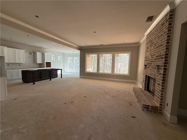 unfurnished living room featuring ornamental molding, a brick fireplace, and baseboards