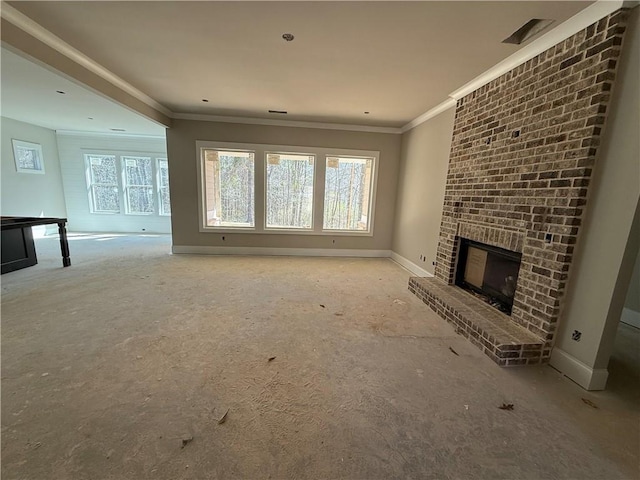 unfurnished living room featuring a brick fireplace, crown molding, and baseboards