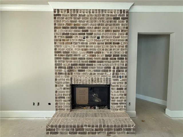 room details featuring a brick fireplace, baseboards, and ornamental molding