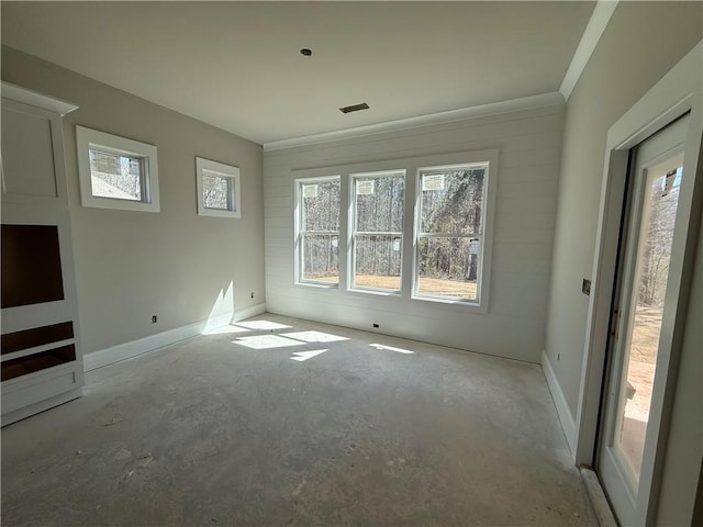 empty room with visible vents, unfinished concrete flooring, and baseboards