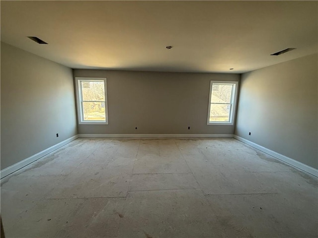 unfurnished room with visible vents and baseboards