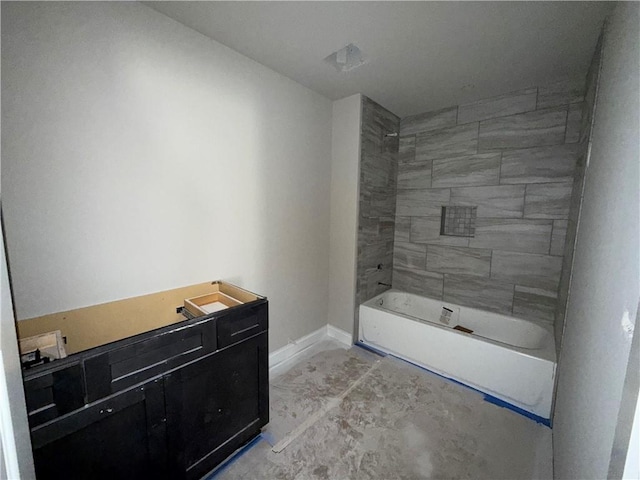 bathroom with concrete floors and baseboards