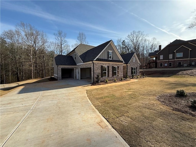 view of front facade with metal roof, a garage, concrete driveway, board and batten siding, and a standing seam roof