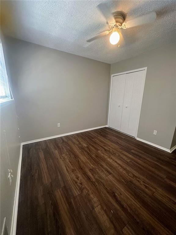 4701 Flat Shoals Rd, Union City, GA 30291 - unfurnished bedroom featuring dark wood finished floors, a textured ceiling, a closet, and ceiling fan