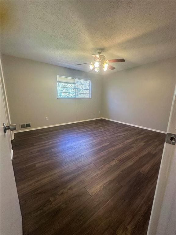 4701 Flat Shoals Rd, Union City, GA 30291 - unfurnished room with ceiling fan, dark wood-style floors, and a textured ceiling