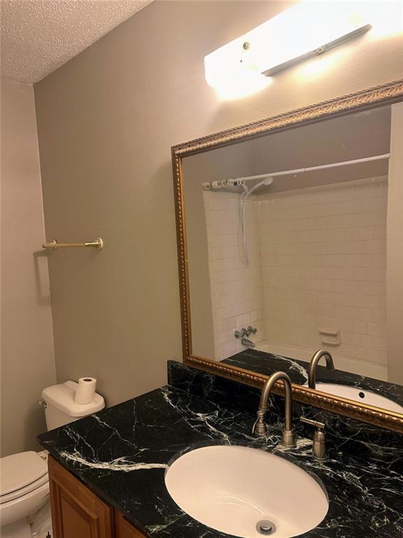 4701 Flat Shoals Rd, Union City, GA 30291 - full bath with vanity, a textured ceiling, and shower / bathtub combination