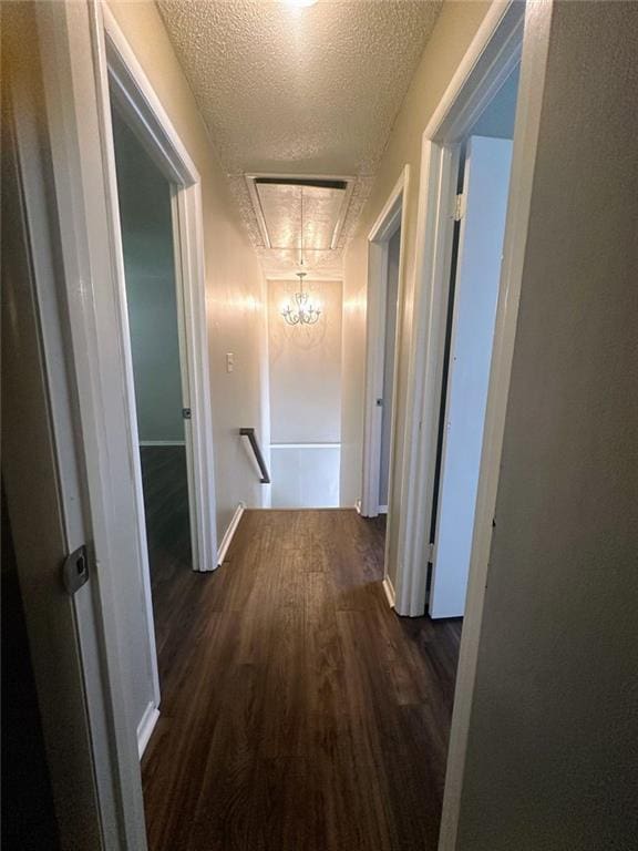4701 Flat Shoals Rd, Union City, GA 30291 - hallway with wood finished floors, a textured ceiling, a chandelier, and an upstairs landing
