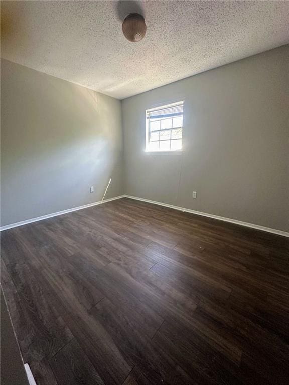 4701 Flat Shoals Rd, Union City, GA 30291 - unfurnished room with a textured ceiling and dark wood finished floors