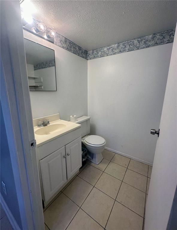 4701 Flat Shoals Rd, Union City, GA 30291 - bathroom with a textured ceiling, vanity, and tile patterned flooring