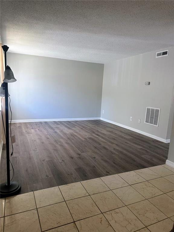4701 Flat Shoals Rd, Union City, GA 30291 - unfurnished living room featuring dark wood-type flooring and a textured ceiling