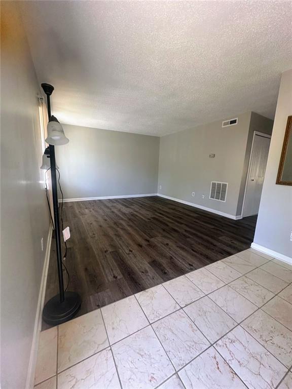 4701 Flat Shoals Rd, Union City, GA 30291 - unfurnished room featuring wood finished floors and a textured ceiling