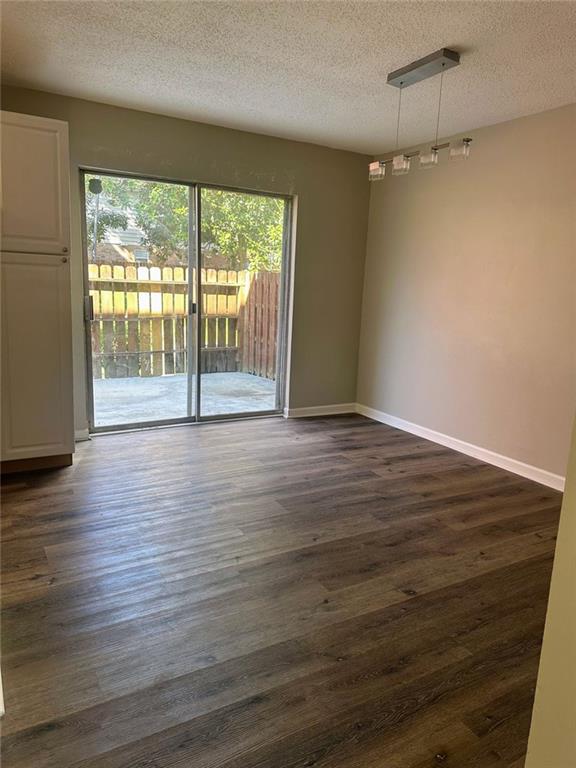 4701 Flat Shoals Rd, Union City, GA 30291 - unfurnished room with a textured ceiling and dark wood-style flooring