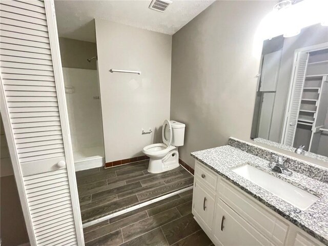 unfurnished bedroom featuring carpet floors, ceiling fan, baseboards, and a textured ceiling