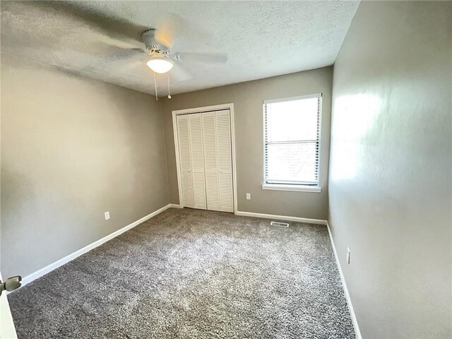 bathroom with visible vents, shower / bathing tub combination, toilet, vanity, and baseboards