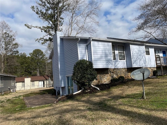 view of property exterior featuring a yard and a chimney