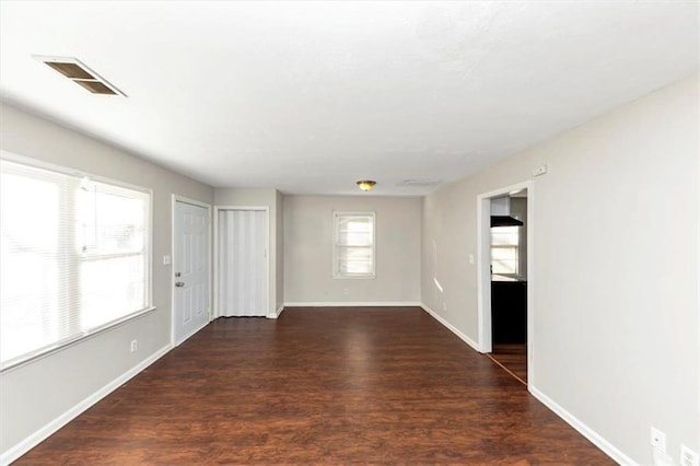 unfurnished room with dark hardwood / wood-style floors