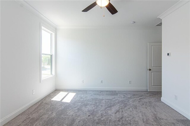 carpeted spare room featuring ceiling fan and ornamental molding