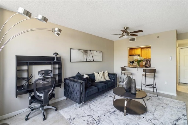 1280 W Peachtree St NW Unit 810, Atlanta, GA 30309 - living area featuring visible vents, a textured ceiling, ceiling fan, and baseboards
