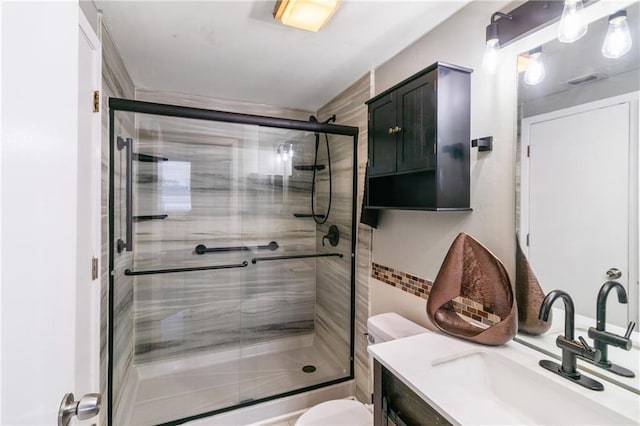 1280 W Peachtree St NW Unit 810, Atlanta, GA 30309 - bathroom with vanity, a shower with door, and toilet
