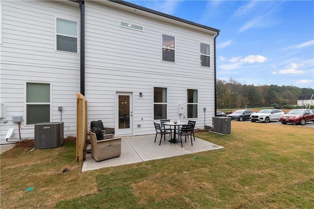 back of property with a patio, a lawn, and central air condition unit