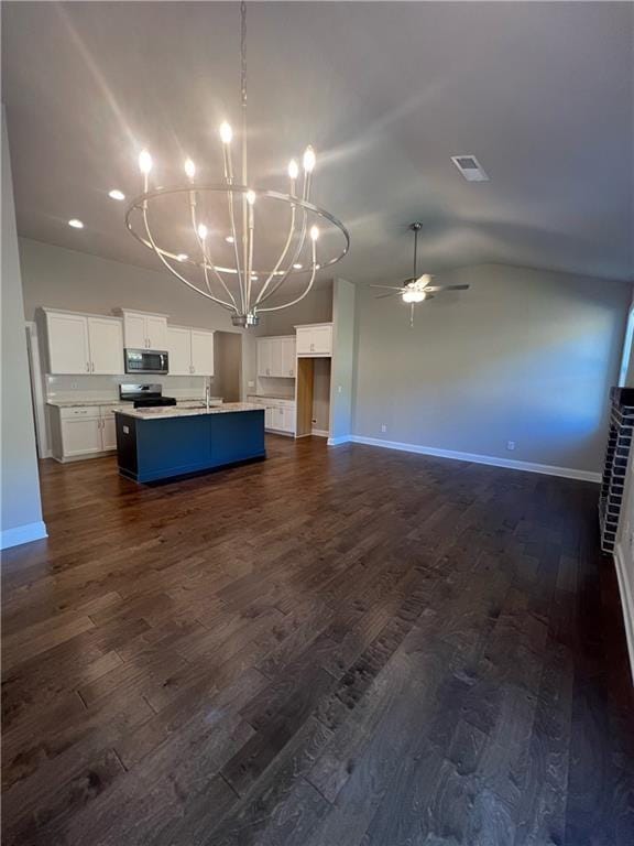 kitchen with dark hardwood / wood-style floors, sink, white cabinets, a kitchen island with sink, and stainless steel appliances