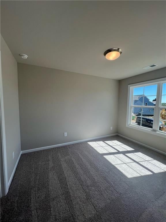 unfurnished room featuring carpet