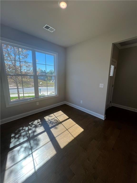 unfurnished room with dark hardwood / wood-style flooring