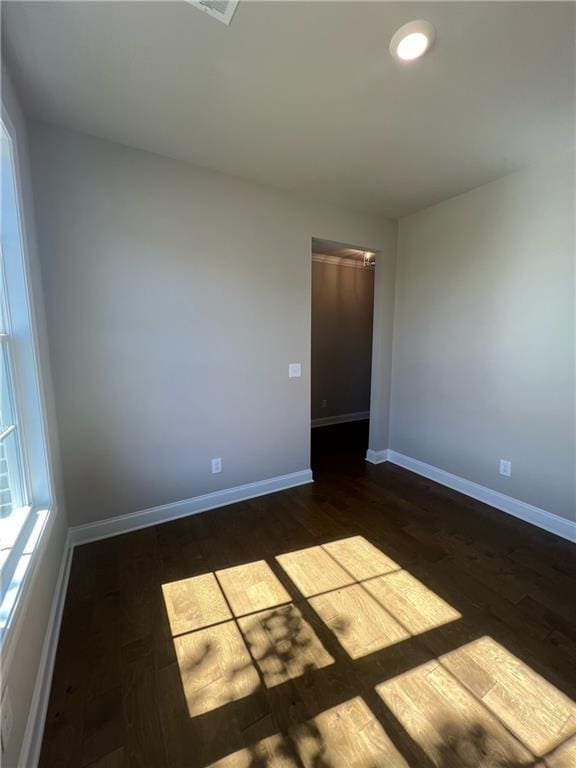 unfurnished room featuring dark wood-type flooring