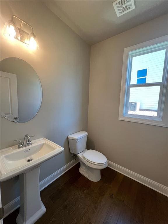 bathroom featuring hardwood / wood-style floors and toilet