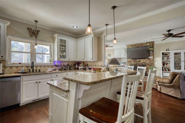 kitchen featuring a sink, stainless steel dishwasher, glass insert cabinets, open floor plan, and ceiling fan