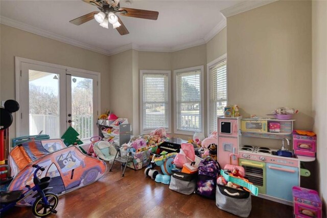 playroom with french doors, crown molding, ceiling fan, and wood finished floors
