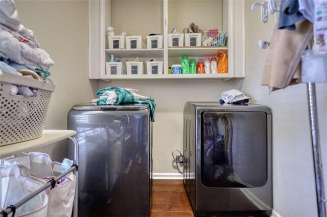 laundry room with independent washer and dryer, laundry area, baseboards, and dark wood-style flooring