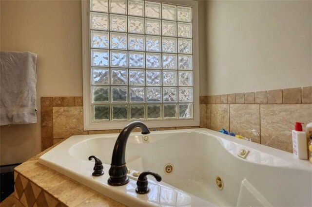 bathroom with a tub with jets