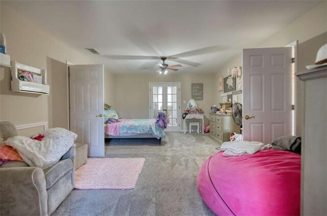 carpeted bedroom featuring ceiling fan, visible vents, and french doors