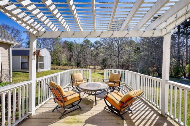 deck featuring an outdoor structure, a pergola, a yard, and a storage shed