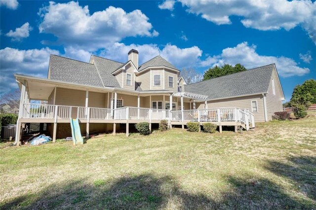 rear view of property with a yard, a chimney, a deck, and a pergola