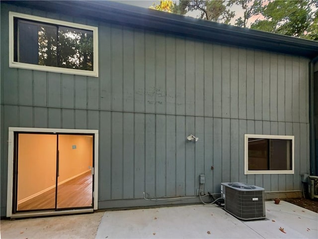 back of house with a patio area and central AC