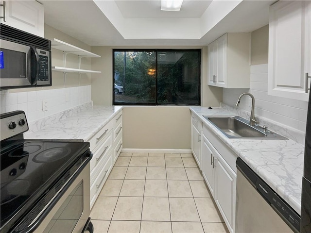 kitchen with white cabinets, tasteful backsplash, stainless steel appliances, and a sink