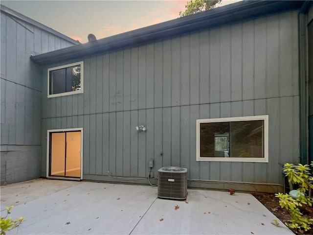 rear view of house featuring a patio and cooling unit