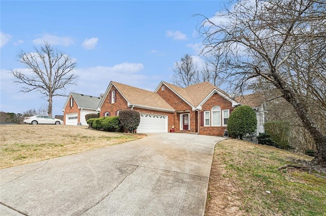 view of front of home with a garage, concrete driveway, brick siding, and a front lawn