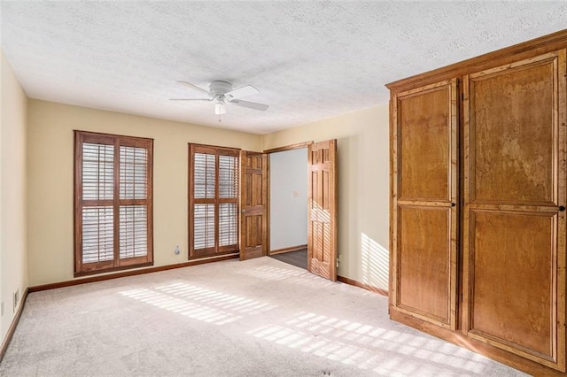 1791 Lake George Dr, Lithia Springs, GA 30122 - unfurnished bedroom featuring baseboards, a textured ceiling, light carpet, and ceiling fan