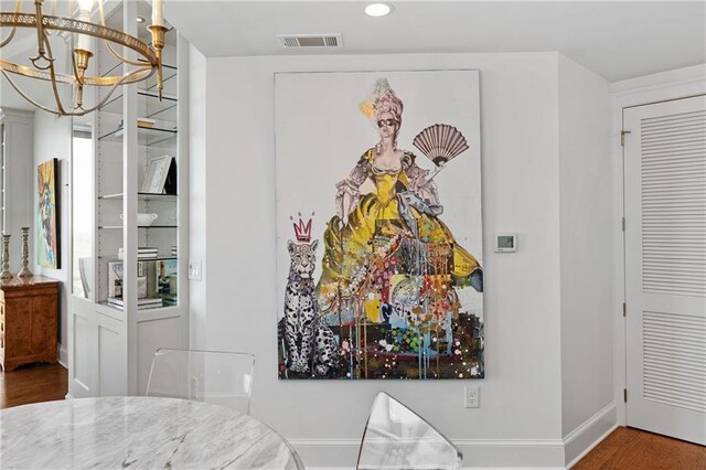 dining area featuring a chandelier, recessed lighting, baseboards, wood finished floors, and visible vents