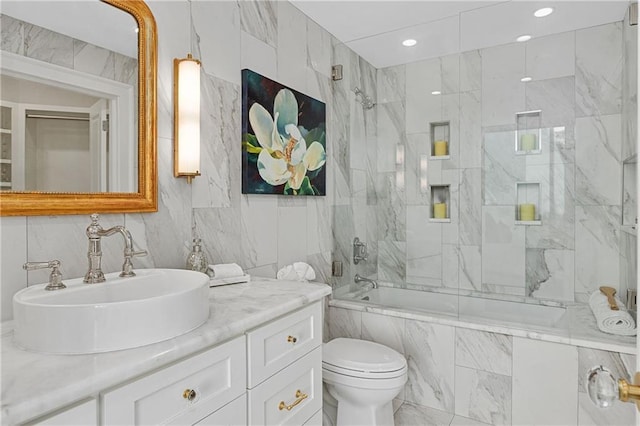 full bath with vanity, toilet, recessed lighting, tile walls, and a combined bath / shower with marble appearance