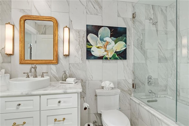 full bath with vanity, bathtub / shower combination, toilet, and tile walls