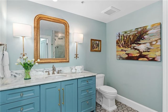 bathroom with visible vents, vanity, baseboards, toilet, and a shower with door