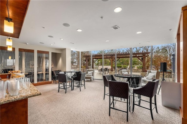 dining room featuring visible vents, recessed lighting, a wealth of natural light, and light colored carpet