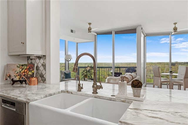 interior details with a sink, ceiling fan, dishwashing machine, and visible vents