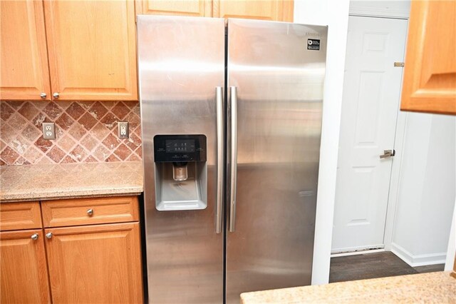 kitchen featuring electric stove, light stone counters, and backsplash