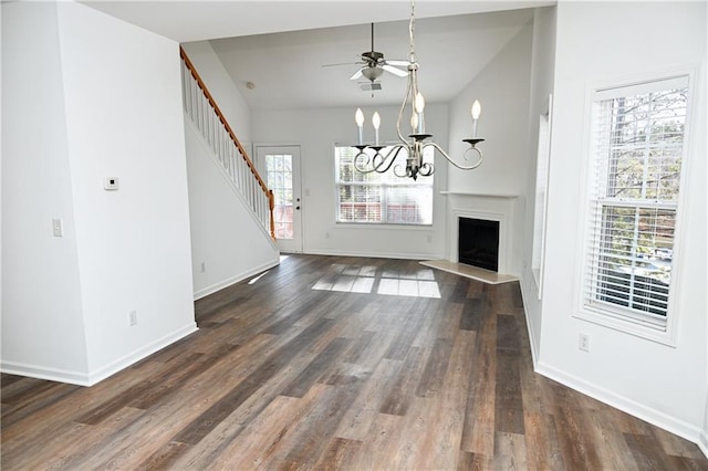 unfurnished living room featuring dark hardwood / wood-style floors and an inviting chandelier