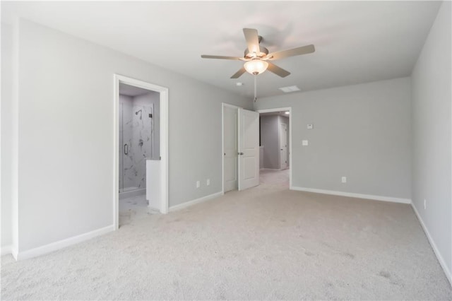 unfurnished bedroom featuring ceiling fan, light colored carpet, and ensuite bath